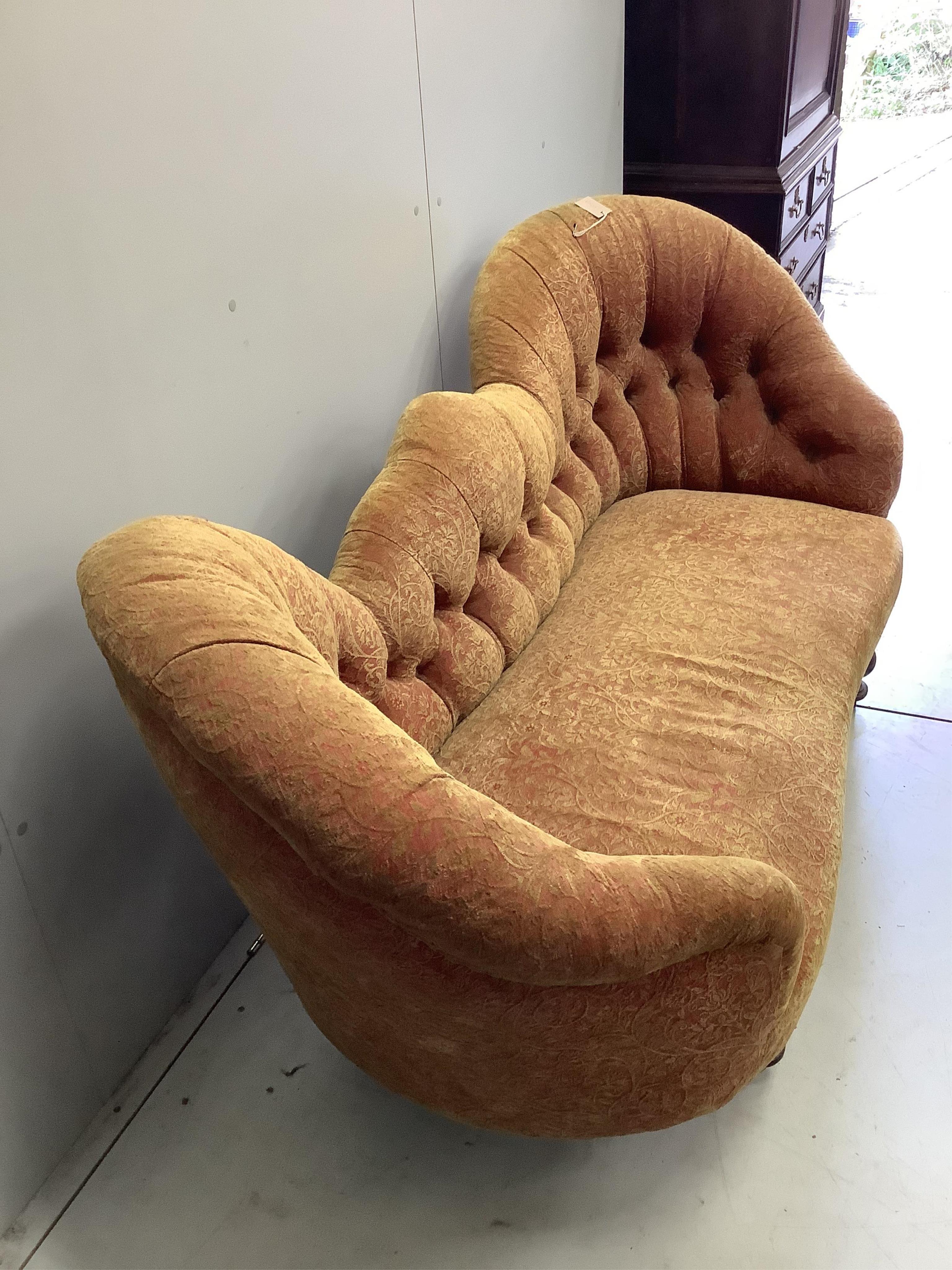 A Victorian double spoon back settee recently re-upholstered in buttoned patterned red and gold fabric, width 180cm, depth 72cm, height 83cm. Condition - good